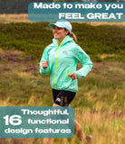Woman running in a field wearing a light blue jacket with promotional text about product features.