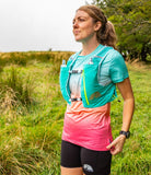 Woman wearing Artemis 5L Race Vest in Waterfall blue running on trail