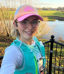 Trail runner wearing pink Trail Goddess Eos Lite Waterproof Cap - lifestyle shot