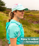 Woman trail runner adjusting Artemis vest straps for custom fit