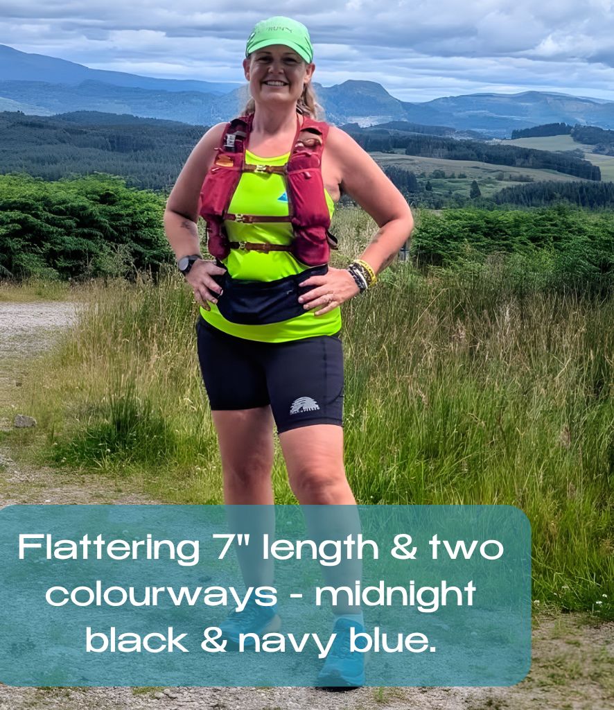 Person in running gear standing outdoors with mountains in the background